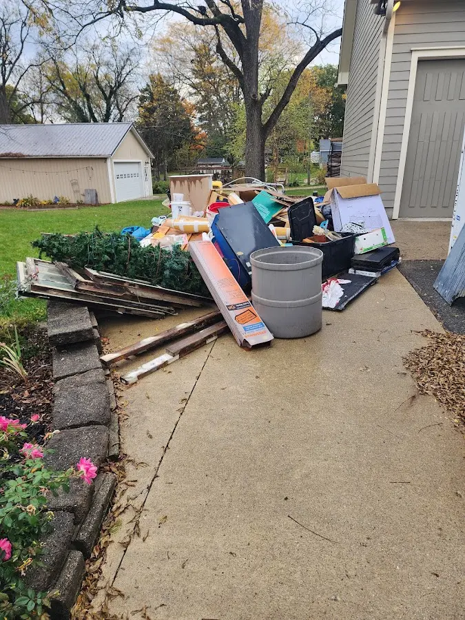 Dumpster being loaded with debris for Estate Cleanout Dumpster Rental in Echols County
